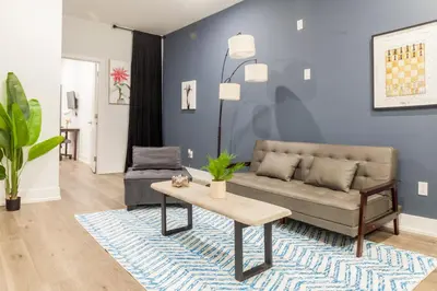 a living room with a couch and a table at Central Philly 2BR2BAWiFi WDSleeps 4-6 in Philadelphia