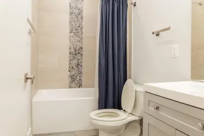 a bathroom with a toilet and a tub and a sink at Central Philly 2BR2BAWiFi WDSleeps 4-6 in Philadelphia