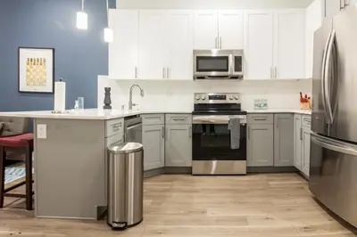 a kitchen with white cabinets and stainless steel appliances at Central Philly 2BR2BAWiFi WDSleeps 4-6 in Philadelphia