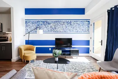 a living room with blue and white stripes at 1BDRM & AptWifi near TrendyEateriesBrewerytown in Philadelphia