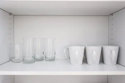 a row of glass vases sitting on a shelf at 1BDRM & AptWifi near TrendyEateriesBrewerytown in Philadelphia