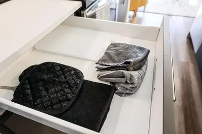 a white drawer with a remote control and a towel at 1BDRM & AptWifi near TrendyEateriesBrewerytown in Philadelphia
