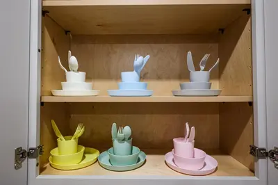 a cupboard filled with lots of bowls and plates at Chill in Style Anime Themed Escape in Philadelphia
