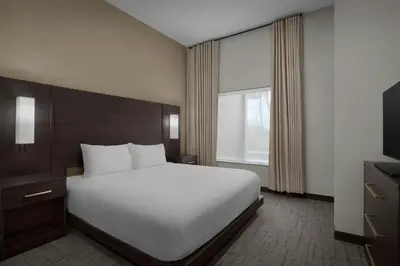 a bedroom with a white bed and a television at Residence Inn by Marriott Newark, DE in Newark