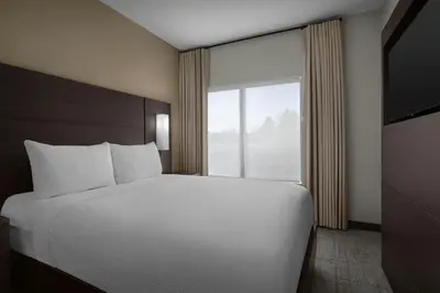 a bedroom with a bed and a large window at Residence Inn by Marriott Newark, DE in Newark