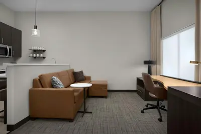 a living room with a couch and a table at Residence Inn by Marriott Newark, DE in Newark