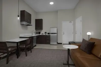 a kitchen and living room with a couch and a table at Residence Inn by Marriott Newark, DE in Newark