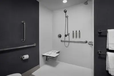 a bathroom with a shower and a toilet and towels at Residence Inn by Marriott Newark, DE in Newark