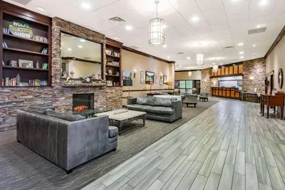 a lobby with two couches and a fireplace at Wyndham Garden York in York