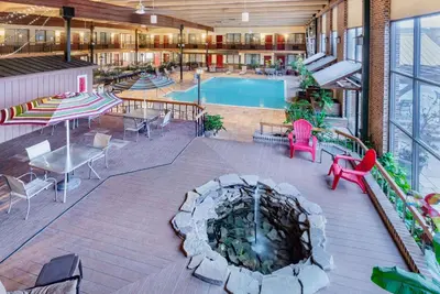 an indoor patio with a pool and a fire pit at Wyndham Garden York in York