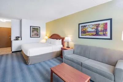 a hotel room with a bed and a couch at Wyndham Garden York in York
