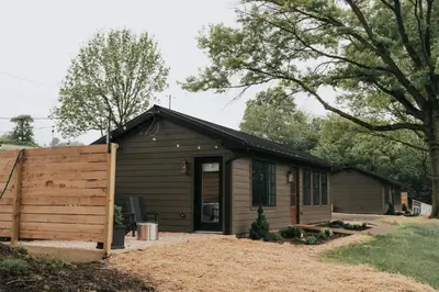 a small house with a fence in front of it at Luxury Cabin at Beaver Creek with Hot tub and stunning views in Strasburg