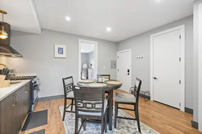 a kitchen and dining room with a table and chairs at Luxury and Chic 2BR 2BA Apt Mins to NYC and Hoboken in Jersey City