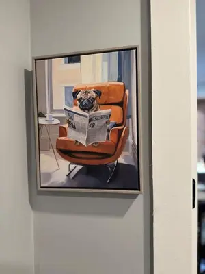 a picture of a dog sitting in a chair with a newspaper at Luxury and Chic 2BR 2BA Apt Mins to NYC and Hoboken in Jersey City