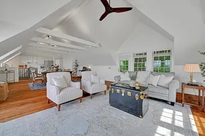 a living room with a couch and a table at The Boat House Water Views Sunsets in York