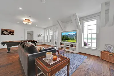 a living room with a couch and a pool table at The Boat House Water Views Sunsets in York