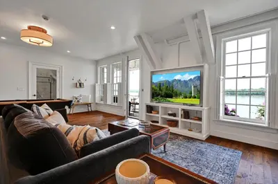 a living room with a couch and a flat screen tv at The Boat House Water Views Sunsets in York