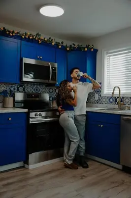 a man and a woman standing in a kitchen at Azure on the Pocono in Tobyhanna
