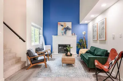 a living room with a green couch and a fireplace at Azure on the Pocono in Tobyhanna