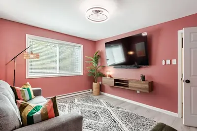 a living room with red walls and a tv at Azure on the Pocono in Tobyhanna