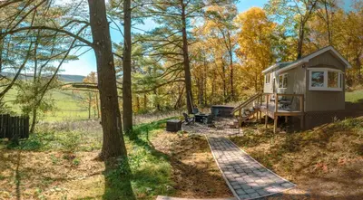 a tiny house in the woods with a staircase at Charming Little House at Buckleberry View EV Recharge Gorgeous View Hot Tub in Spring Mills