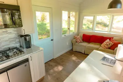 a kitchen and a living room with a couch at Charming Little House at Buckleberry View EV Recharge Gorgeous View Hot Tub in Spring Mills