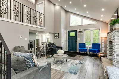 a living room with a couch and blue chairs at Less Than 2 Mi to Big Bass Lake Modern Mtn Chalet! in Gouldsboro