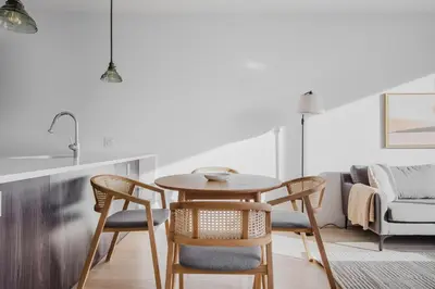 a kitchen and dining room with a table and chairs at Blueground Jersey City EV charging nr park NYC-1690 in New York