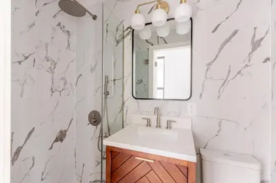 a bathroom with a sink and a mirror at Blueground Manhattan wd AC nr park NYC-1829 in New York