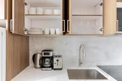a kitchen with a sink and a coffee maker at Blueground Manhattan wd AC nr park NYC-1829 in New York
