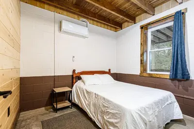 a bedroom with a bed and a window at The River Shack - kayaks, fishing, quiet, family in Delta