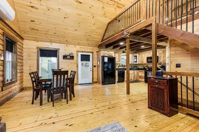 a dining room and kitchen in a log cabin at The River Shack - kayaks, fishing, quiet, family in Delta