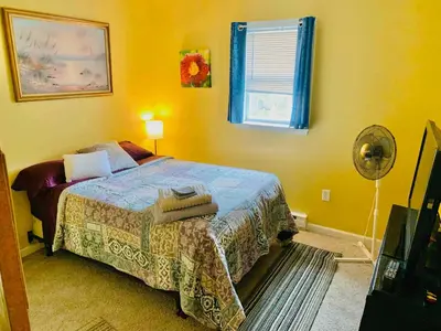 a bedroom with a bed and a window and a fan at Honesdale Escape ~ A Place to Remember - Apartment in Honesdale