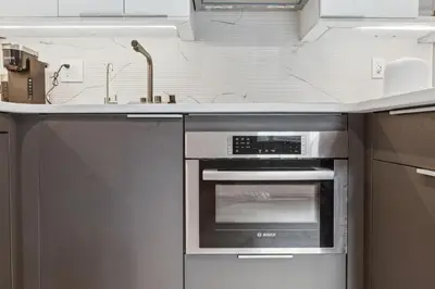 a kitchen with a sink and an oven at 24 Stay - Philadelphia Rittenhouse in Philadelphia