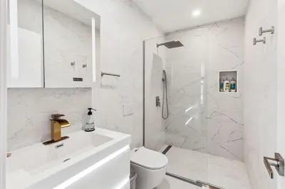 a white bathroom with a toilet and a shower at 24 Stay - Philadelphia Rittenhouse in Philadelphia