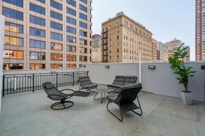 a balcony with chairs and a table on a building at 24 Stay - Philadelphia Rittenhouse in Philadelphia