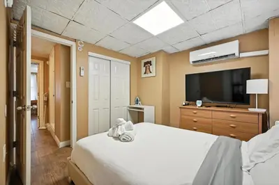 a bedroom with a white bed and a tv at Charming Philly Stay Walk to Liberty Bell & More in Philadelphia