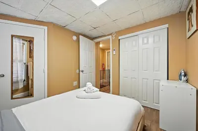 a bedroom with a white bed and a mirror at Charming Philly Stay Walk to Liberty Bell & More in Philadelphia