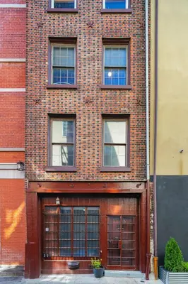 a brick building with two garage doors on it at Charming Philly Stay Walk to Liberty Bell & More in Philadelphia