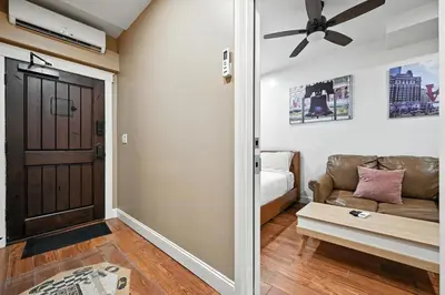 a living room with a couch and a ceiling fan at Cozy Modern Studio Perfect for Short or Long Stays in Philadelphia
