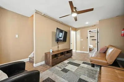 a living room with a couch and a flat screen tv at Heart of Downtown Delight in Philadelphia