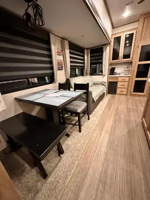 a living room with a table and a bed at Luxury Lakeside Retreat - The Cozy Wondrous Weekendator in Lake Ariel