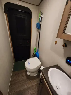a small bathroom with a toilet and a sink at Luxury Lakeside Retreat - The Cozy Wondrous Weekendator in Lake Ariel