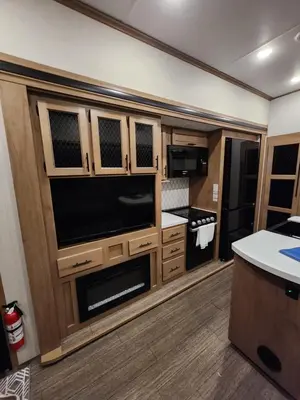 a kitchen with a large entertainment center with a large television at Luxury Lakeside Retreat - The Cozy Wondrous Weekendator in Lake Ariel
