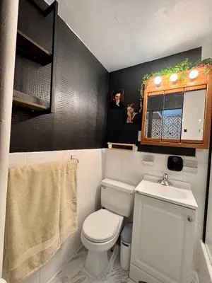 a bathroom with a white toilet and a sink at Gotham House in New York