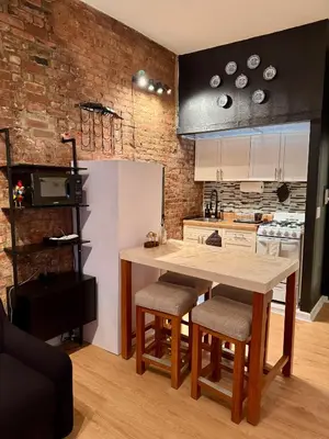 a kitchen with a large wooden table and chairs at Gotham House in New York