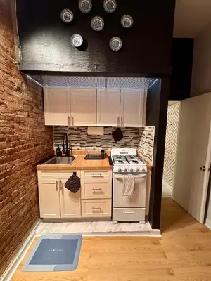 a small kitchen with a stove and a sink at Gotham House in New York