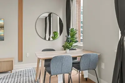 a dining room with a table and a mirror at Aparmint at Five on Canal - Philadelphia in Philadelphia