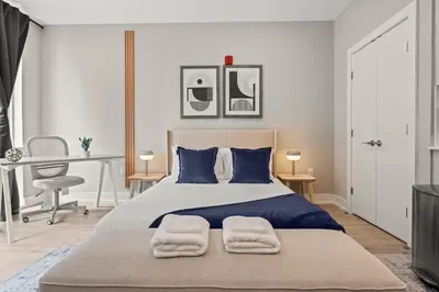 a bedroom with a large bed with two towels on it at Aparmint at Five on Canal - Philadelphia in Philadelphia