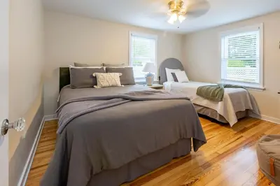 a bedroom with two beds and two windows at Amish Guest House - hottub, patio, swing, ebikes in Gordonville
